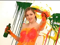 Really beautiful gal uses her own body as canvas when playing with paint